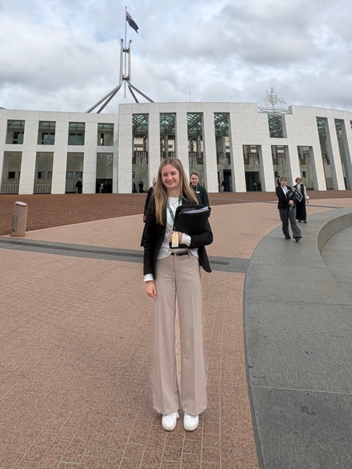 Ella Johnson standing at Parliament House in Canberra during the inaugural National Youth Parliament.